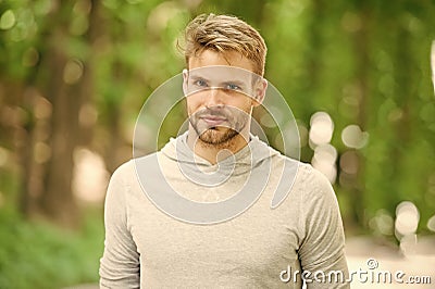 Man with bristle on calm face, nature background, defocused. Skin care concept. Man with beard or unshaven guy looks Stock Photo