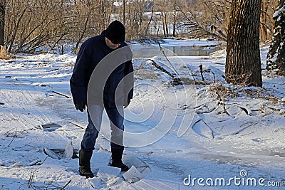 A man broke into the ice in winter. Dangerous thin ice Stock Photo