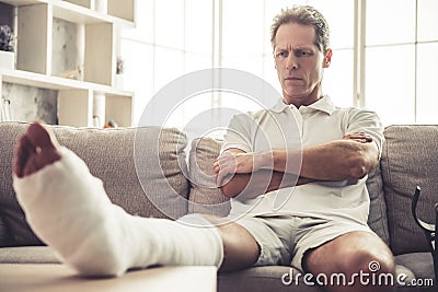 Man with broken leg Stock Photo