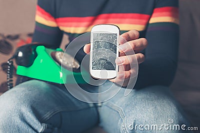 Man with broken smart phone and rotary telephone Stock Photo