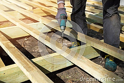 Man building wooden frame for patio deck Stock Photo