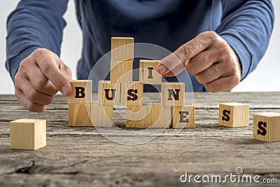 Man building the word Business with blocks Stock Photo