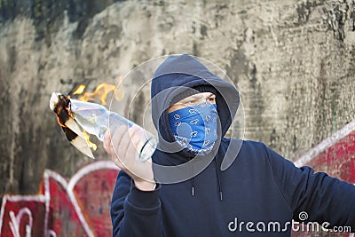 Man with a burning Molotov cocktail Stock Photo