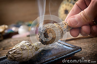 Man burning white sage incense Stock Photo