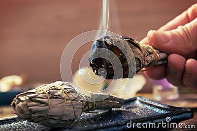 Man burning white sage incense Stock Photo
