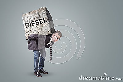 Person burdened by a heavy stone with the word DIESEL on it Stock Photo