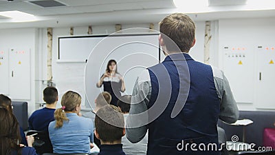 Man at business seminar speaking with lecturer and audience - meeting concept Editorial Stock Photo