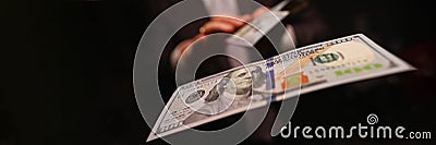 Man in business suit litter money, dollars closeup Stock Photo