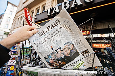 Man buying international press with Emmanuel Macron and Marine l Editorial Stock Photo