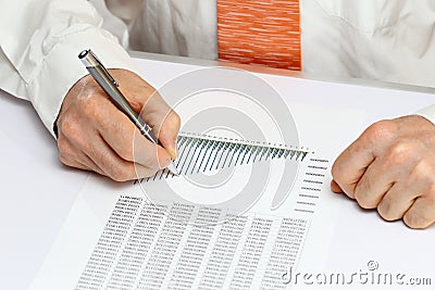 Man is calculating on a desk Stock Photo
