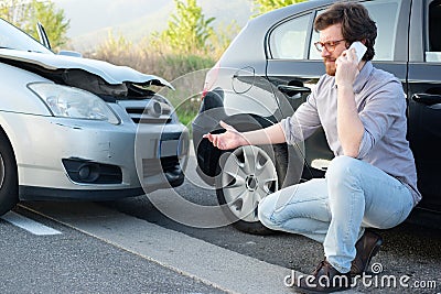 Man calling help after car crash accident on the road Stock Photo