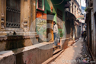 Man with cans of water come in home Editorial Stock Photo