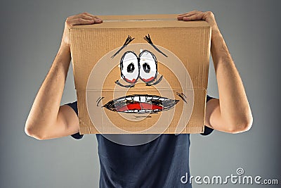 Man with cardboard box on his head and terrified look skethed Stock Photo