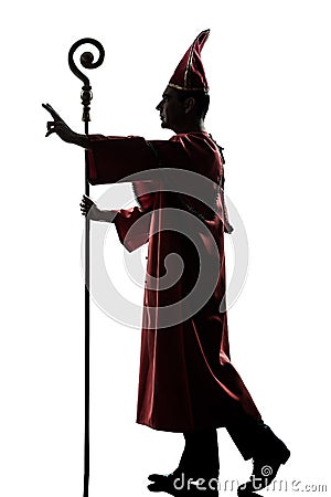 Man cardinal bishop silhouette saluting blessing Stock Photo