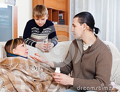 Man caring for sick wife, son helps him Stock Photo