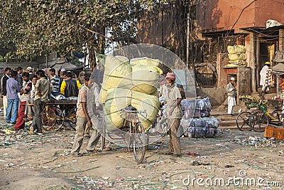 man carries heavy cargo with his rickshaw in old Delhi Editorial Stock Photo