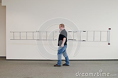 Man carrying a ladder Stock Photo