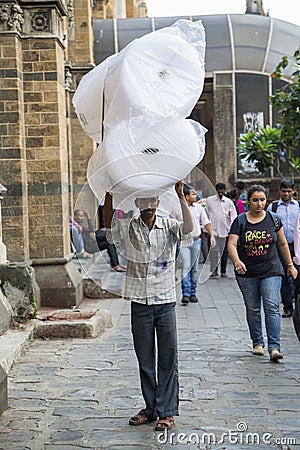 Man carrying weight Editorial Stock Photo