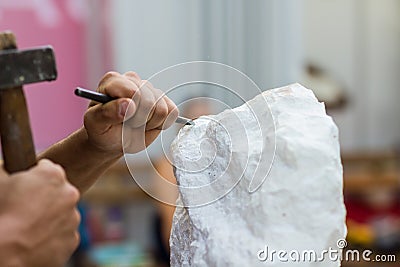 Man carving stone statue Stock Photo