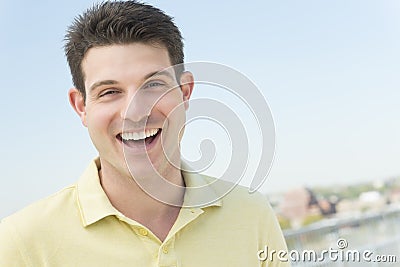 Man In Casual Laughing Against Clear Sky Stock Photo