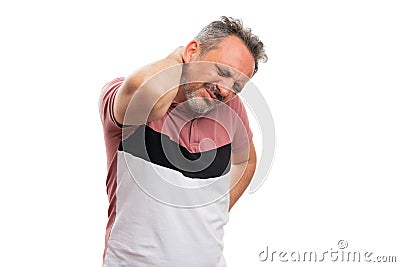 Man in casual tshirt touching back muscular pain with copyspace Stock Photo