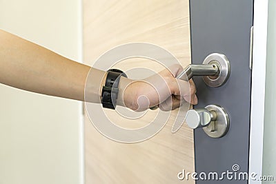 Man catch Door Handles stainless steel on door wood to open Stock Photo