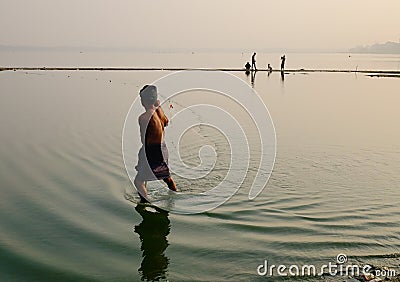 A man catching fishes on the lake in Mandalay, Myanmar Editorial Stock Photo