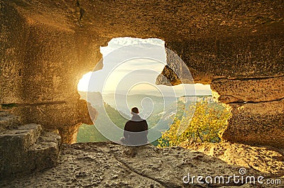 Man in cave mountain. Stock Photo