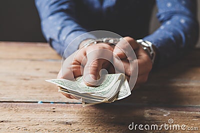 A man in chains holds money. court corruption concept Stock Photo