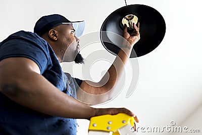 Man changing light bulb lamp Stock Photo