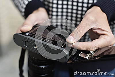 Man changing the roll film of his camera Stock Photo