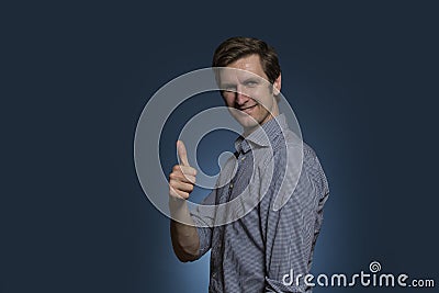 Man Turning Towards Camera Smiling and Giving the Thumbs Up Stock Photo