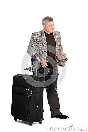 Man in a checkered suit and luggage Stock Photo