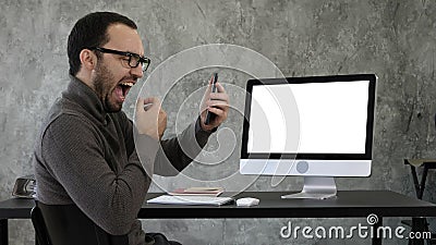 Man checking his teeth in the office near computer screen. White Display. Stock Photo