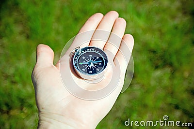 Man checking retro compass for directions Stock Photo
