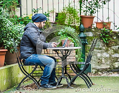 Man checking social media on his tablet and looking his smartphone Stock Photo