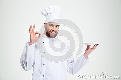 Man chef showing ok sign and empty plat Stock Photo