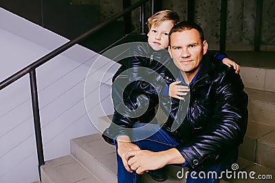 The man with the child in leather jackets Stock Photo