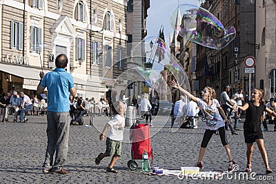 Man and children with large soap bubbles Editorial Stock Photo