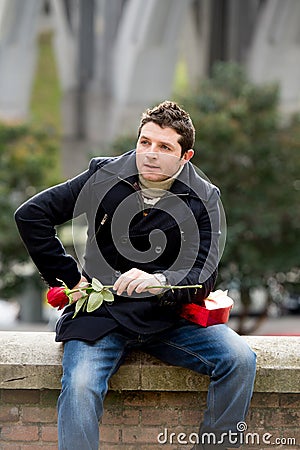 Man with chocolates and a rose being stood up Stock Photo