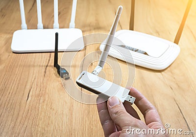 Man choose of different types of Wi-Fi routers, modern and old technology. Wireless ethernet connection signal. USB Wifi Receiver Stock Photo