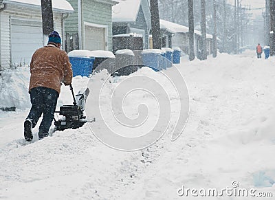 Man is cleaning alley before his garage Editorial Stock Photo