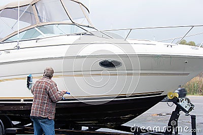 Man cleaning boat hull Stock Photo