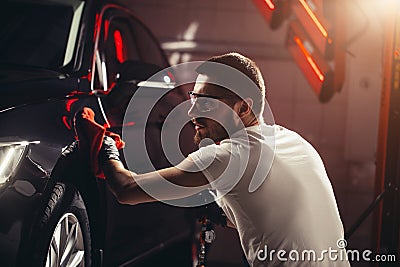 Man cleaning car with microfiber cloth, car detailing or valeting concept Stock Photo