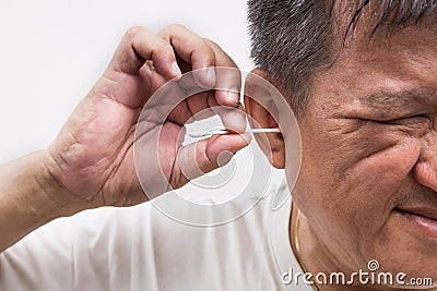 Man cleaning ear with cotton buds stick with ticklish expression Stock Photo