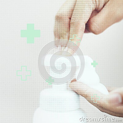 Man cleaning hands with a soap dispenser to prevent Coronavirus Stock Photo