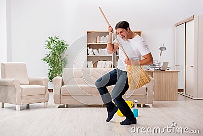 The man cleaning home with broom Stock Photo