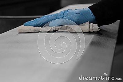 Man cleaning a metal panel with a cloth Stock Photo