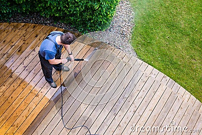 Man cleaning terrace with a power washer - high water pressure c Stock Photo