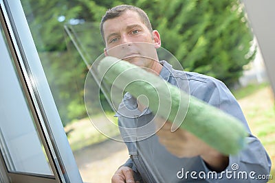 Man cleaning window pane Stock Photo